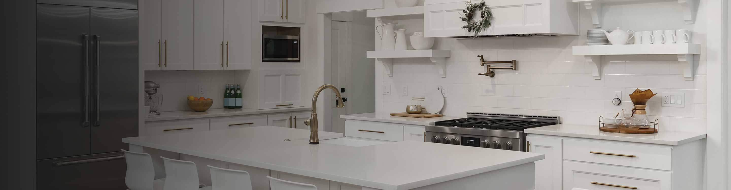 white tile backsplash in a kitchen with white flooring, cabinetry and countertops