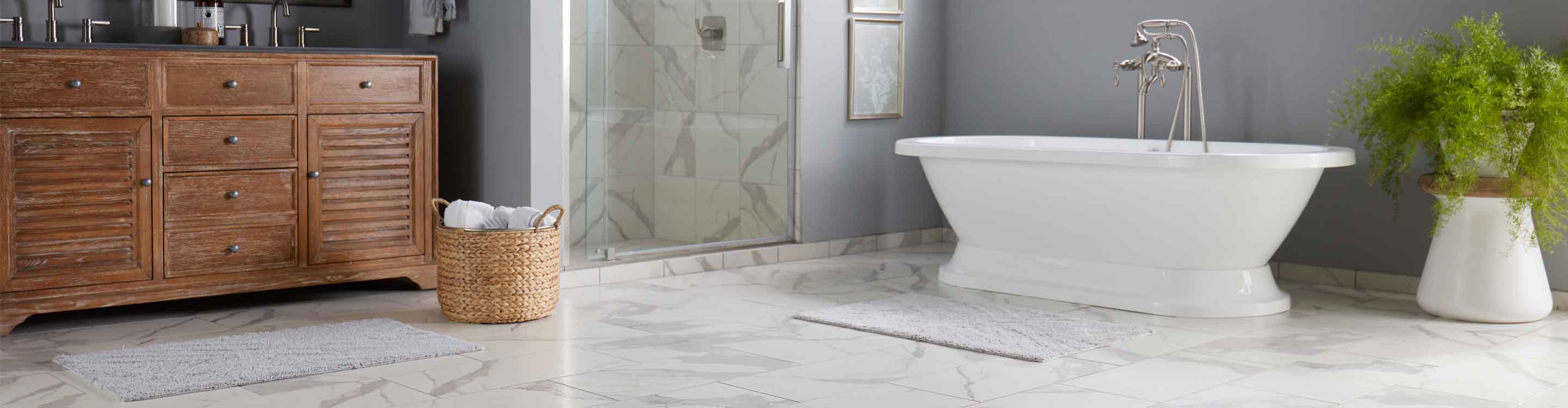 Bathroom with marble look tile flooring and freestanding bathtub